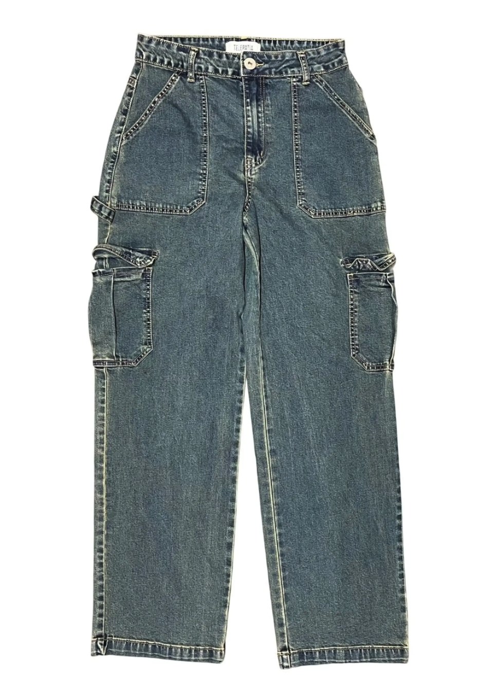 Woman wearing light wash wide-leg jeans with a large dark denim heart patch on the outer thigh, shown from the back with raw hem finish